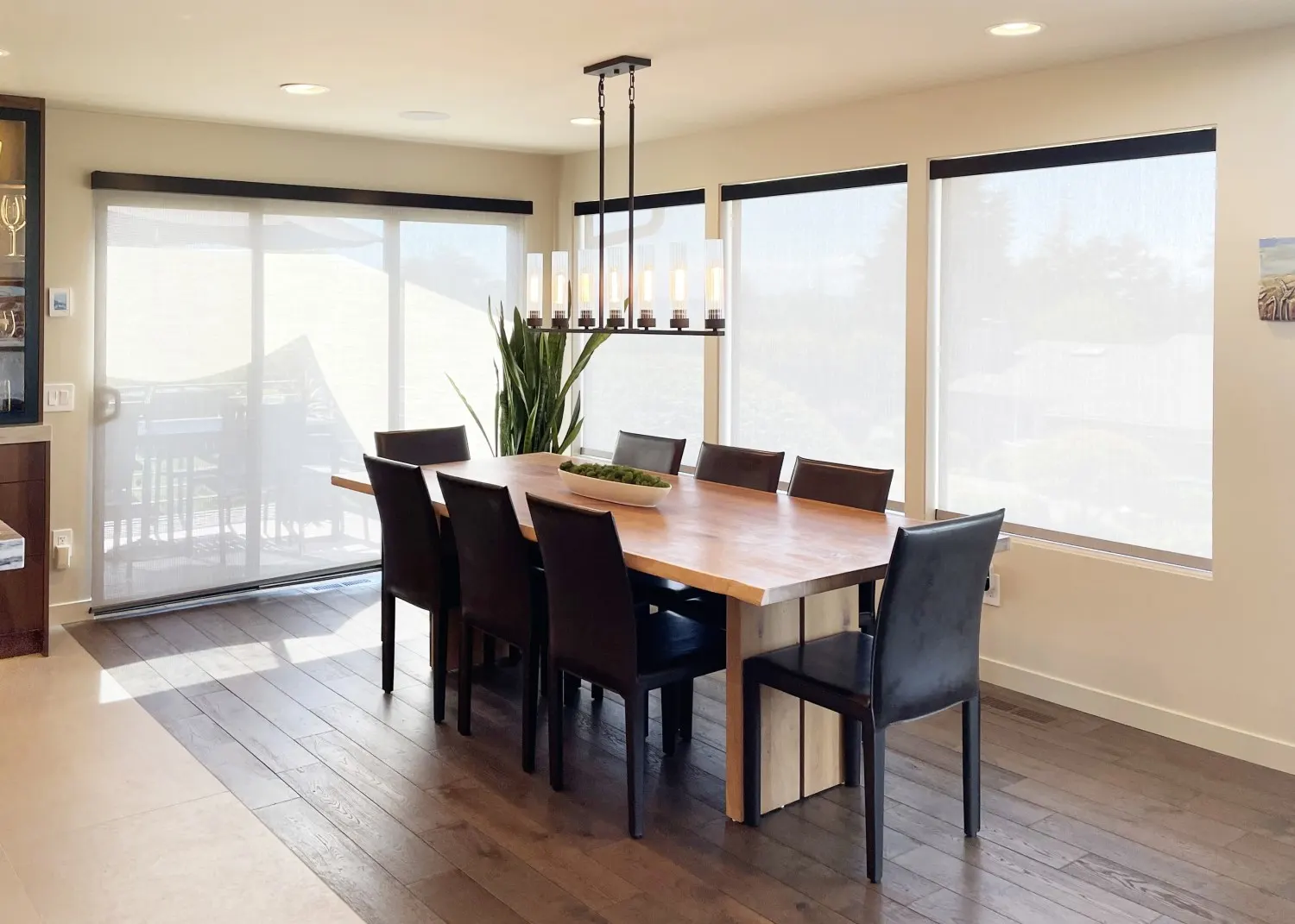 Motorized solar shades raised for dining room windows and sliding glass door in Bellevue