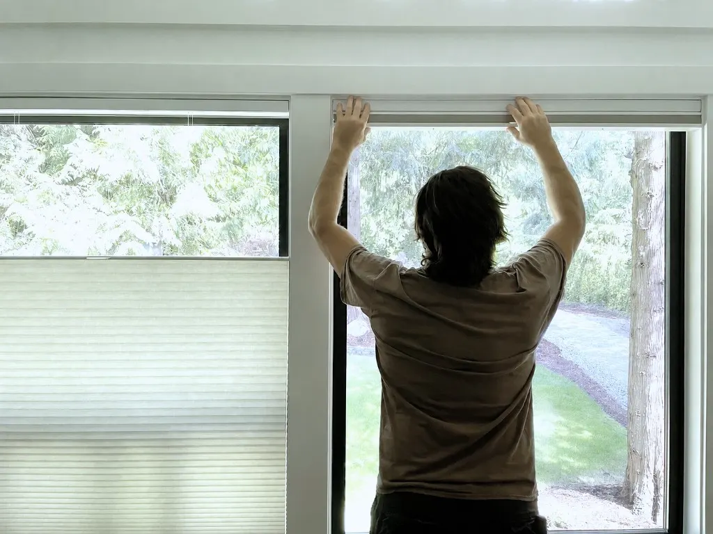 Blinds installer mounting honeycomb shades in Woodinville, WA